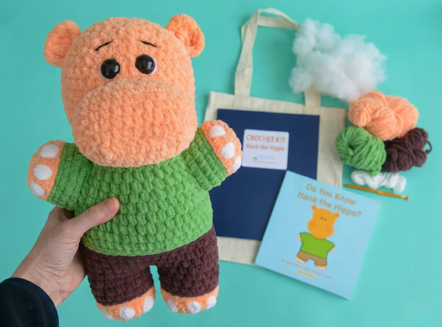 Crochet hippo plushie, beginner amigurumi kit with yarn, stuffing, tote bag, and instruction book