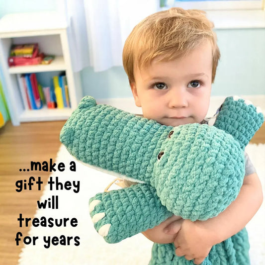 Child hugging a large teal crochet alligator plushie, beginner amigurumi stuffed animal