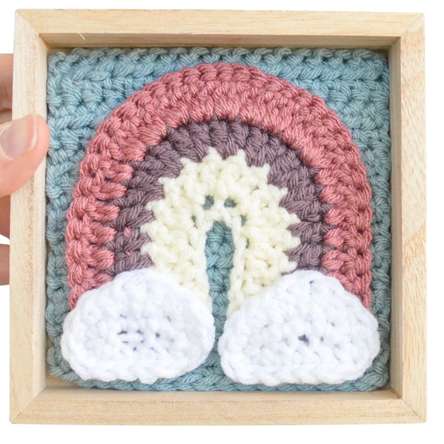 Handmade crochet rainbow applique with clouds in a wooden frame, beginner-friendly decor