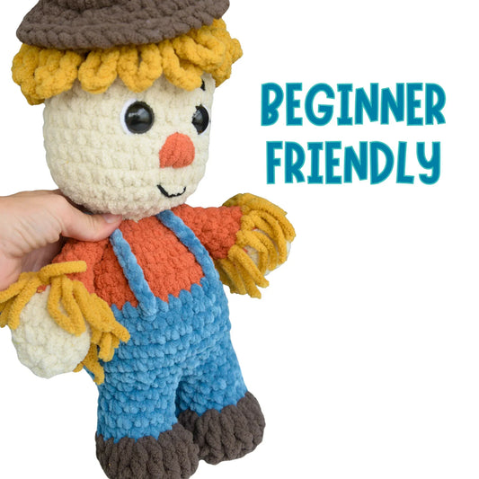Beginner-friendly crochet scarecrow plushie with blue overalls and yarn hair.
