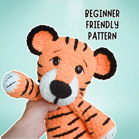 Hand holding crochet tiger plushie, beginner-friendly amigurumi pattern text shown