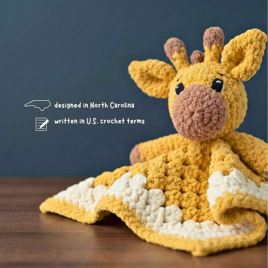 yellow giraffe crochet lovey blanket on wooden surface, plush amigurumi pattern for beginners