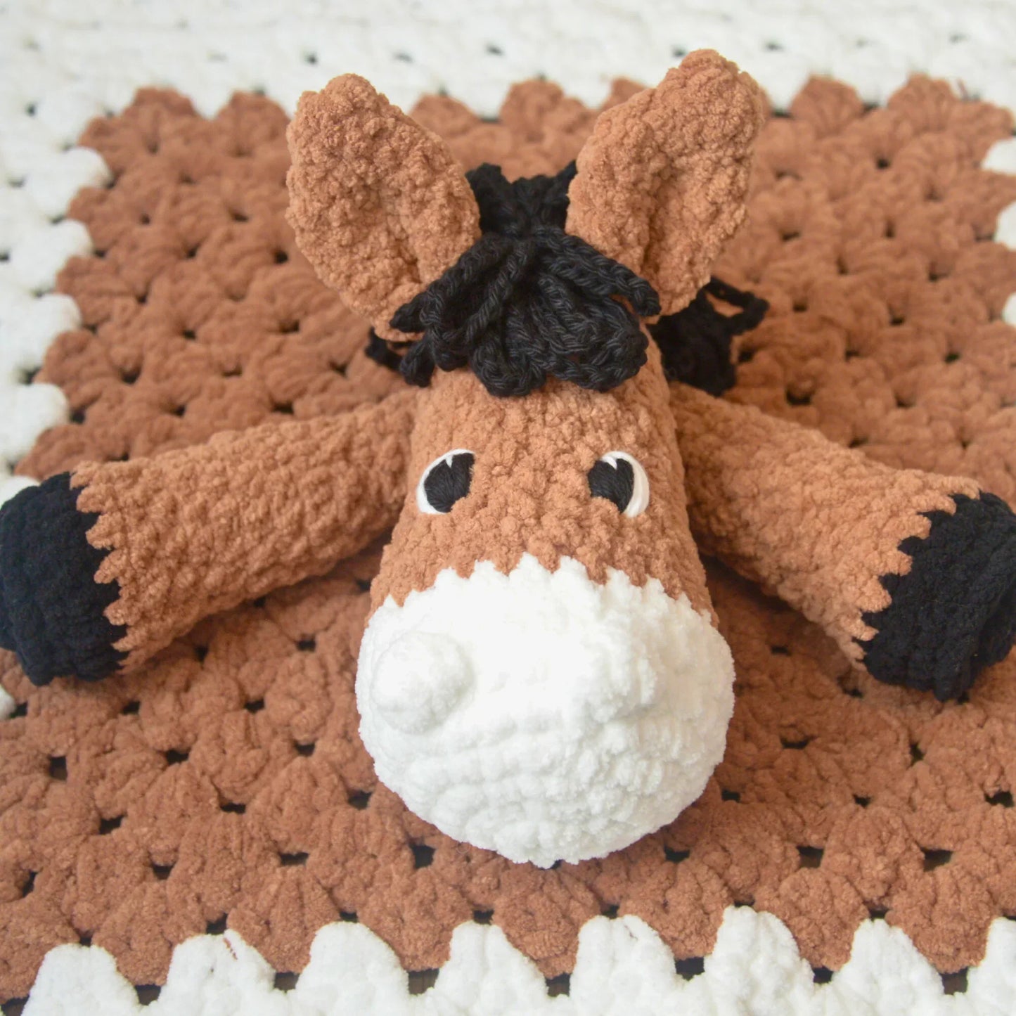Crochet horse lovey baby blanket with plush brown and white horse head and arms
