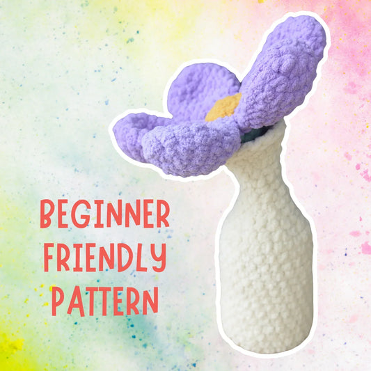 Purple crochet flower in a white vase, beginner-friendly amigurumi pattern text overlay.
