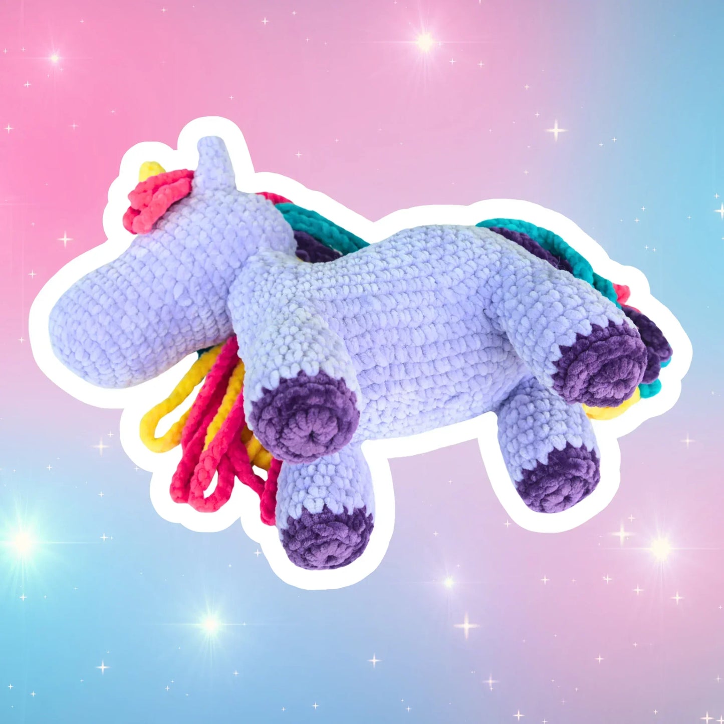 Crochet unicorn plushie with colorful mane on pastel starry background