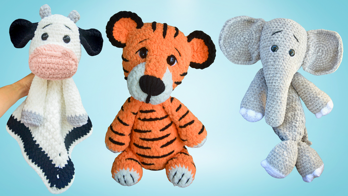 Handmade crochet plush toys including a cow lovey blanket, a tiger stuffed animal, and an elephant stuffed doll