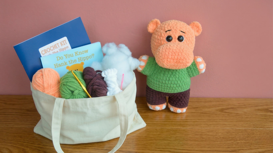 Beginner crochet hippo amigurumi kit with yarn, hook, pattern, and finished plush toy