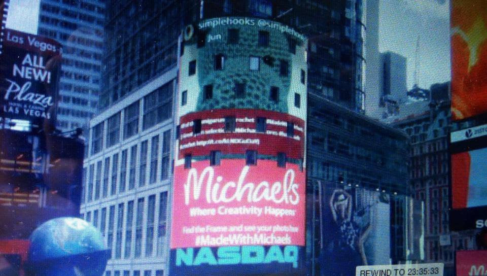 Times Square digital billboard showcasing crochet plushie pattern ad with city buildings