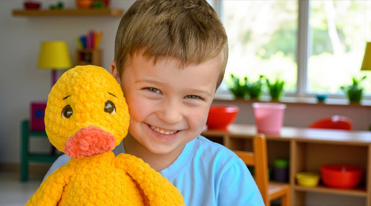 Smiling child holding a large yellow crochet duck plushie in a colorful playroom