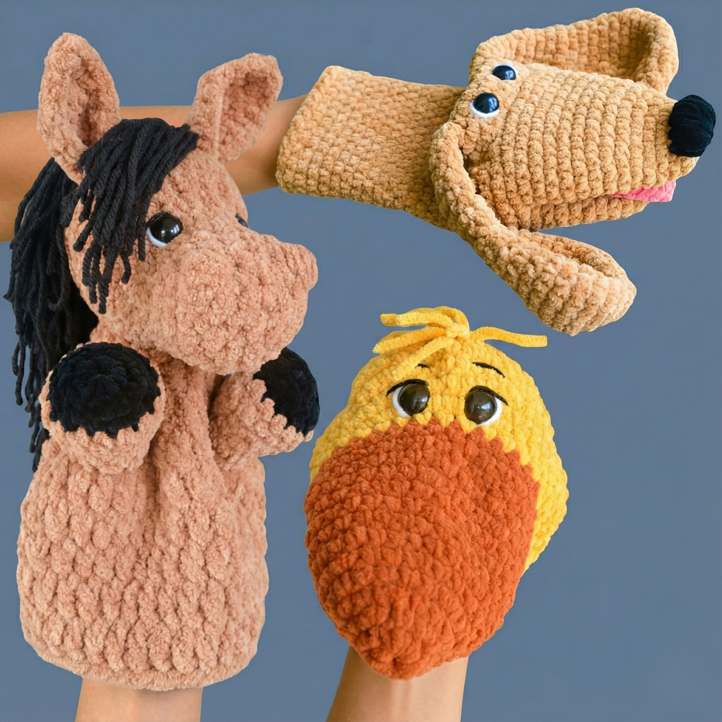 Handmade crocheted animal puppets of a horse, dog, and duck with textured yarn