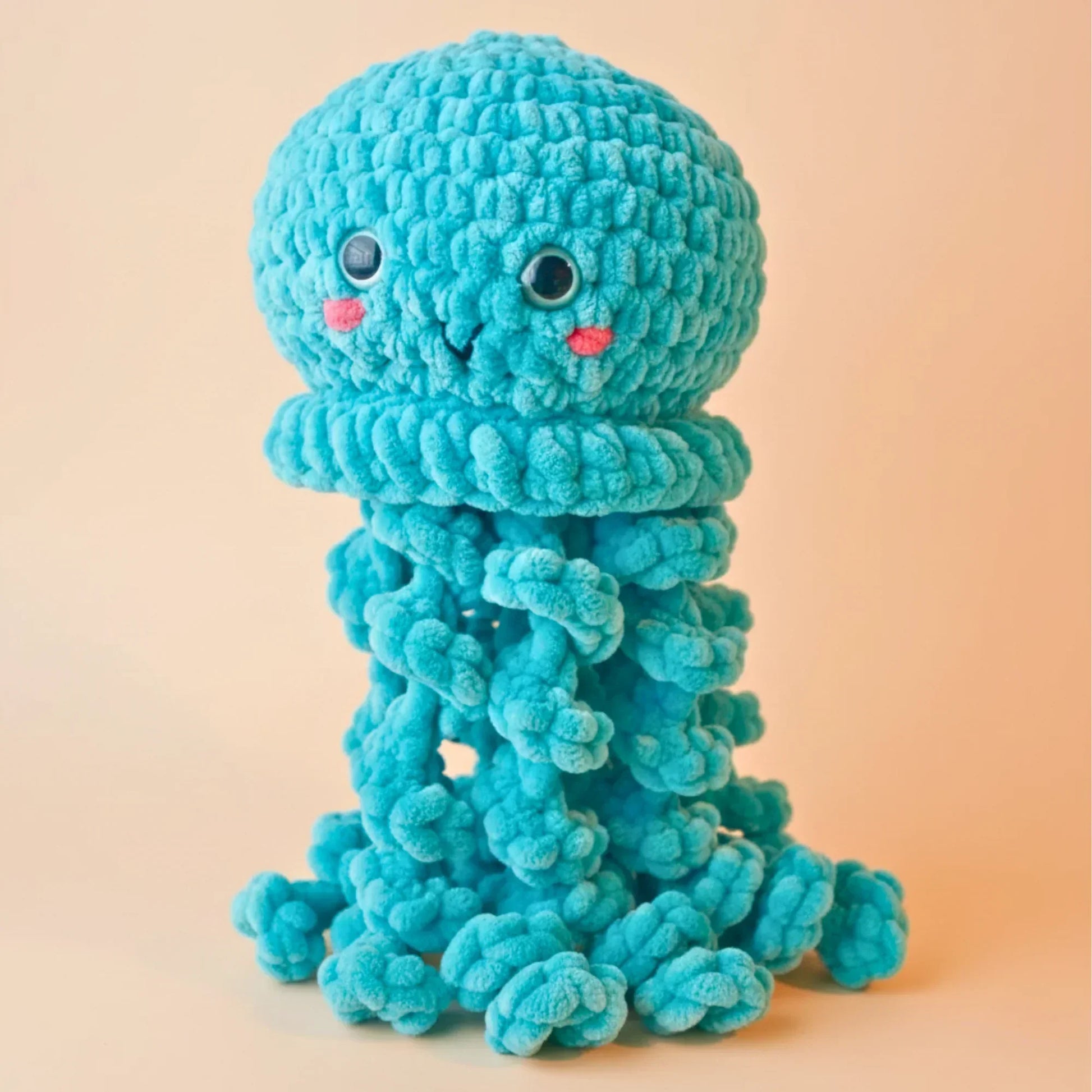 crochet jellyfish plushie amigurumi with blue textured yarn and cute face