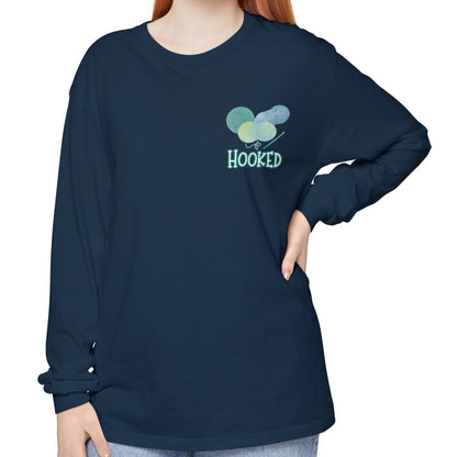 Person wearing a navy blue long-sleeve shirt with a colorful design and text on a white background