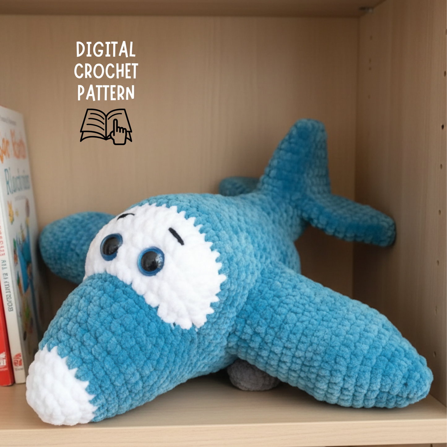 Blue and white crocheted airplane plush toy on wooden shelf with books, digital crochet pattern