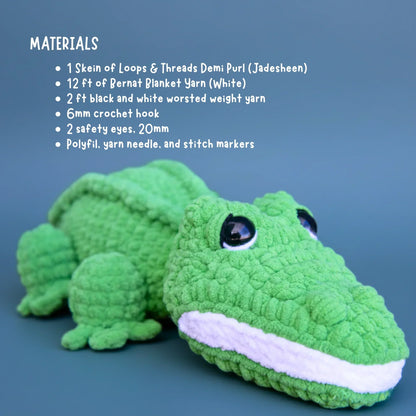 Green crochet alligator plush with materials list for amigurumi pattern on blue background