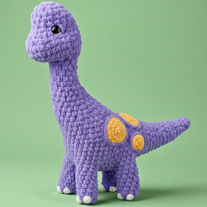 Purple dinosaur toy with yellow spots on a green background