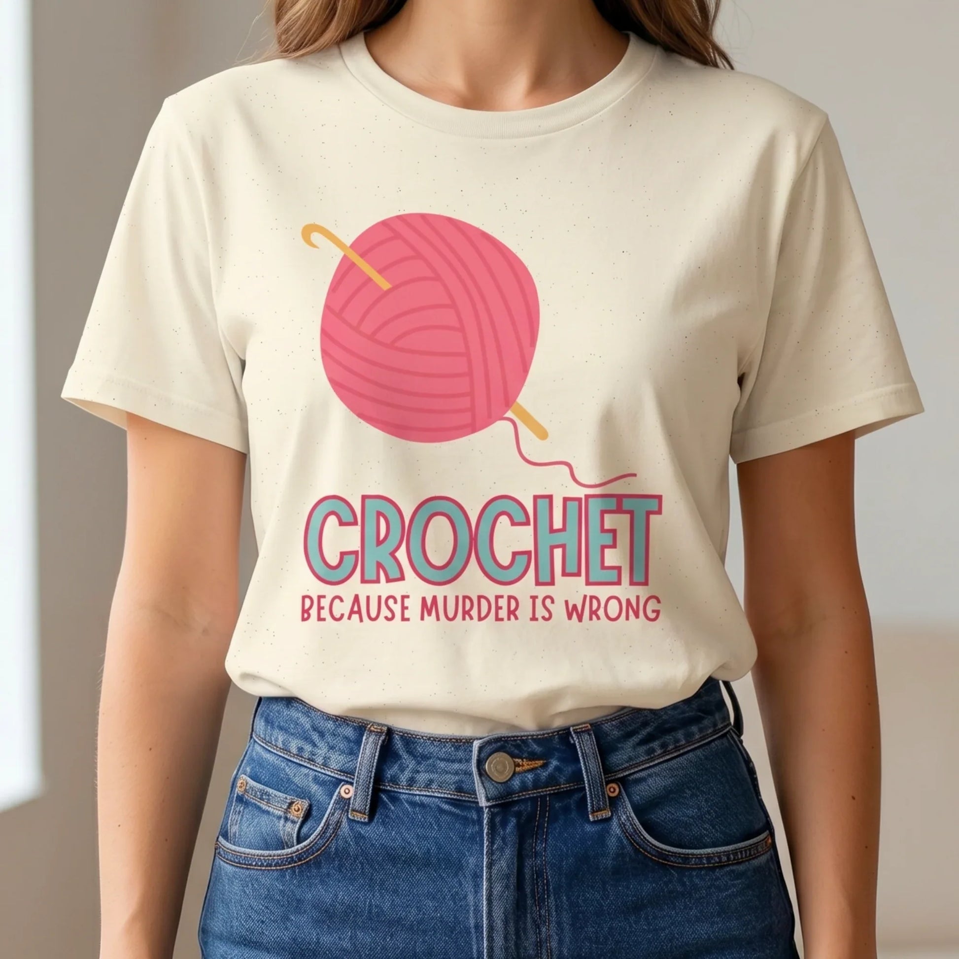 Person wearing a t-shirt with a crochet graphic and text.