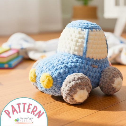 Crocheted toy car on a wooden surface with 'Simply Crochet' pattern logo.