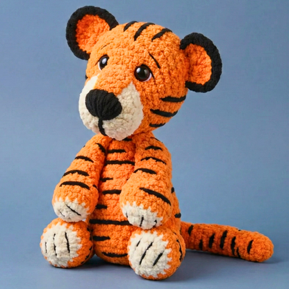 Crocheted tiger toy on a blue background