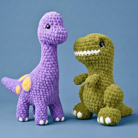 Two crochet dinosaurs, one purple and one green, on a blue background