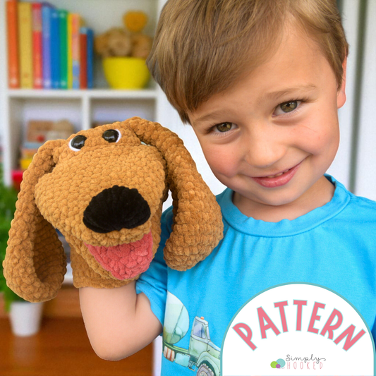 Child holding a brown dog-shaped plush toy with a bookshelf in the background