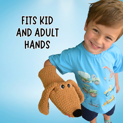 Child holding a brown dog-shaped glove with text 'FITS KID AND ADULT HANDS' on a blue background