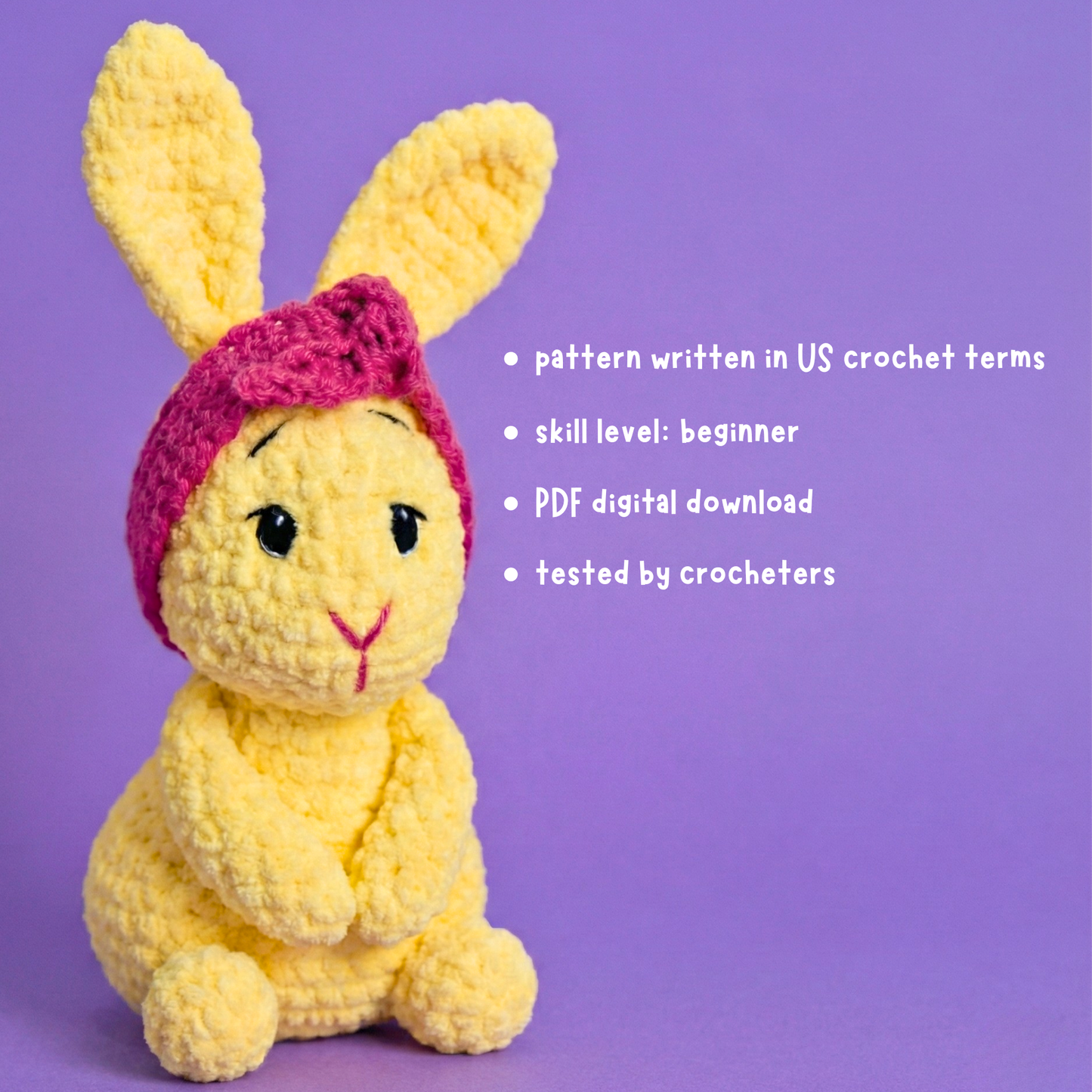 Crocheted yellow bunny with pink hat on a purple background