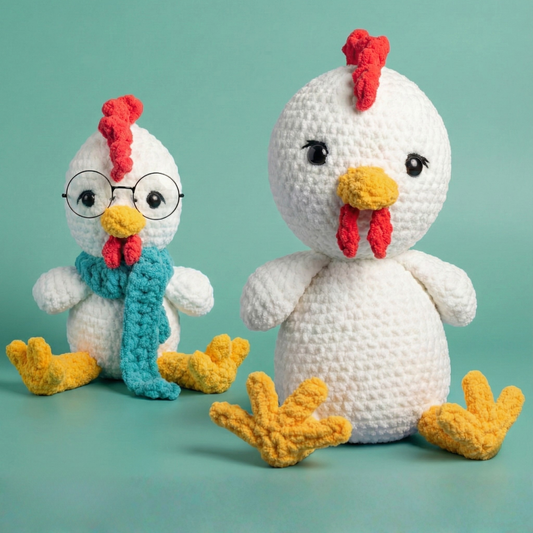 Two crochet chicken plushies with red combs, yellow beaks, and textured white bodies