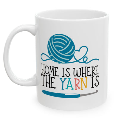White mug with a blue yarn ball and text design on a white background