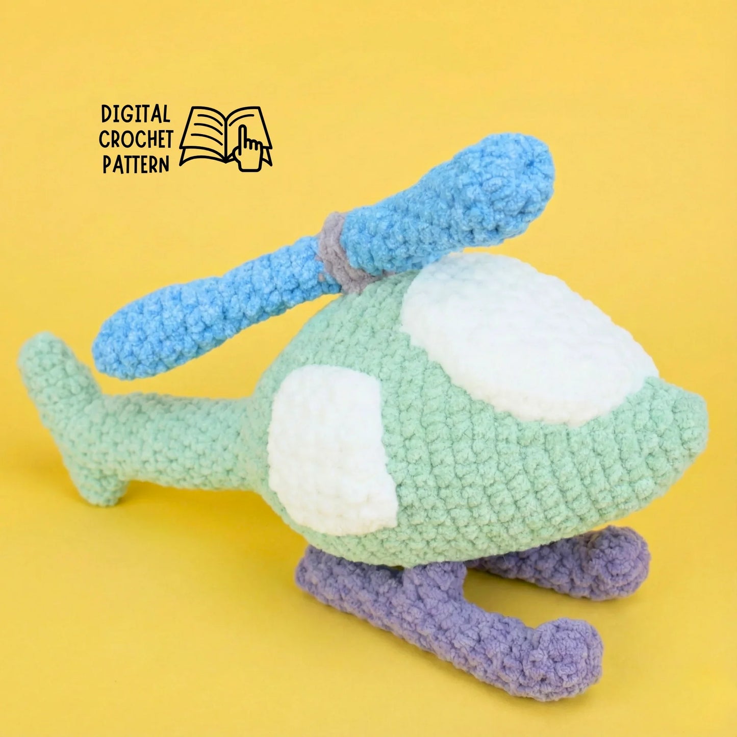 Plush crochet helicopter amigurumi with blue rotors and purple skids on yellow background