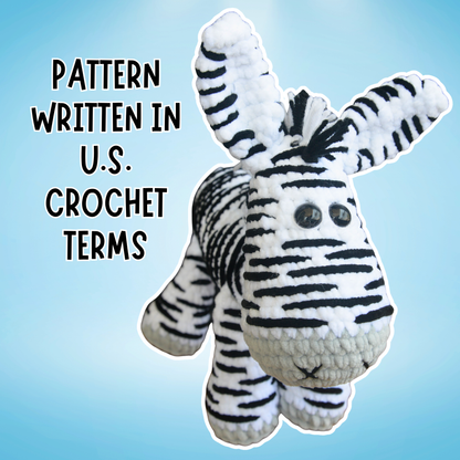 Crocheted zebra toy with text 'Pattern Written in U.S. Crochet Terms' on a blue background