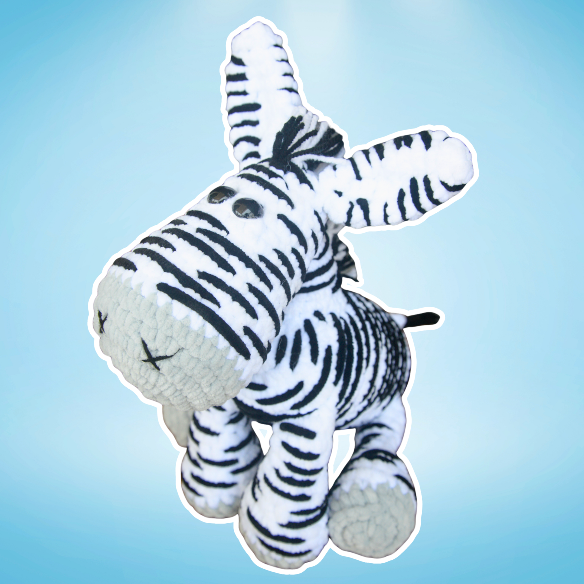 Plush zebra toy on a light blue background