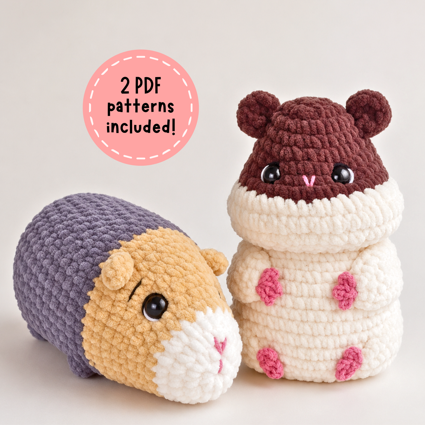 Two crocheted hamster toys on a light beige background, with a pink circular badge that reads '2 PDF patterns included!'. One toy is lying down in purple, tan, and white, and the other is sitting in cream, brown, and pink.
