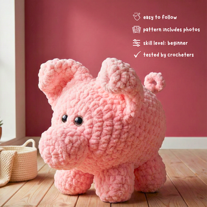Plush pink crocheted pig figurine on wood floor with red wall, beginner crochet pattern