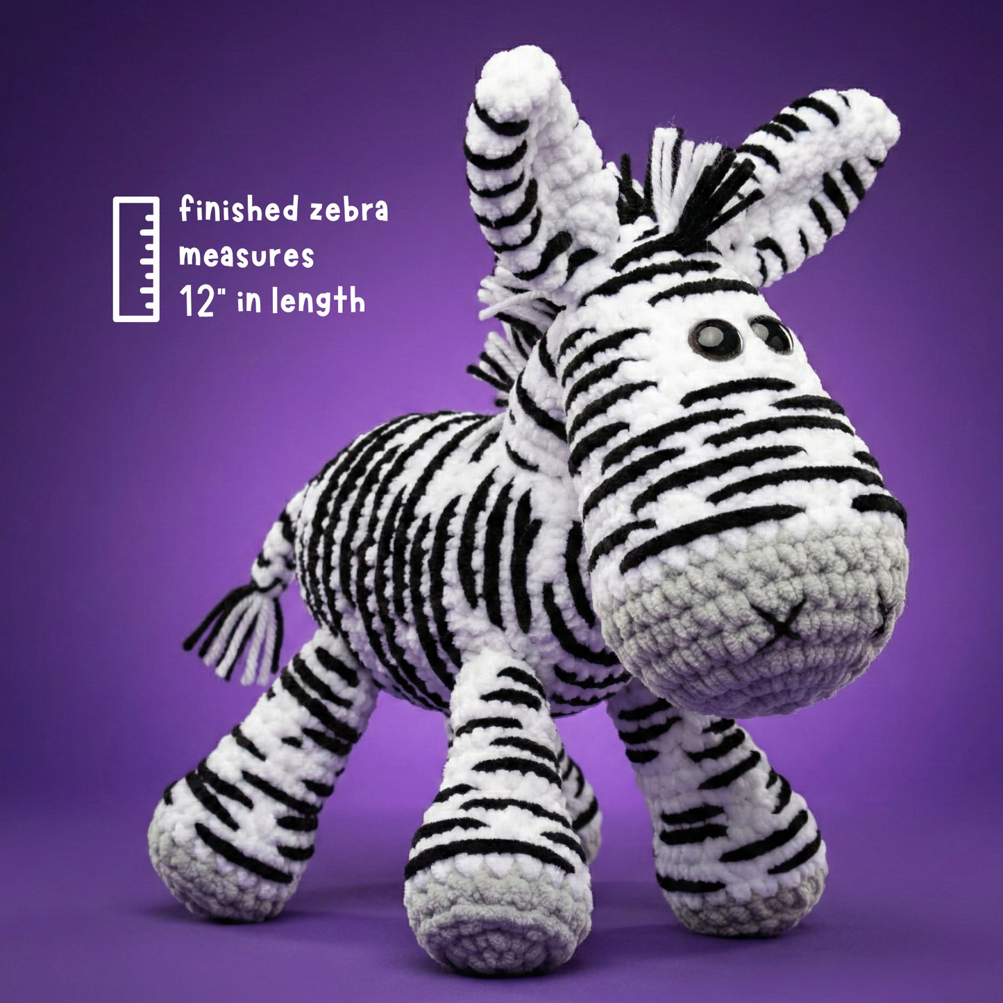 Handmade crochet zebra toy with black and white stripes, 12 inches long, on purple background