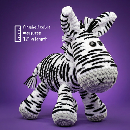 Handmade crochet zebra toy with black and white stripes, 12 inches long, on purple background